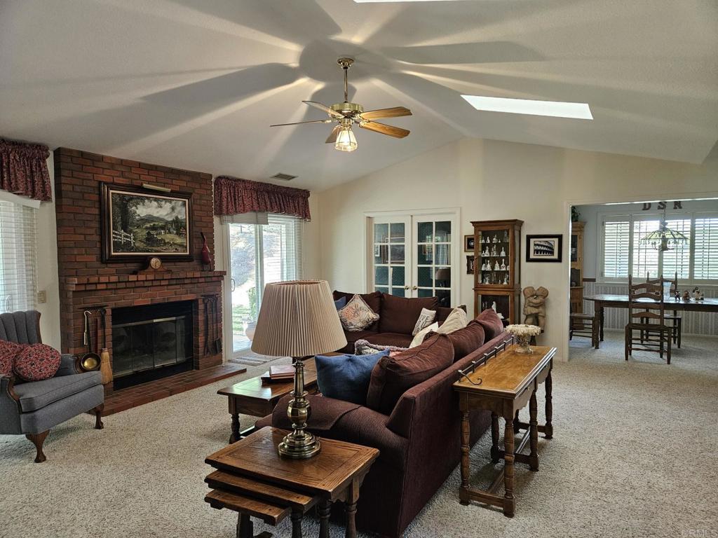 28124 Mountain Meadow Road Escondido, CA 92026 - Photo 11 of 31 a living room with furniture a fireplace and a large window