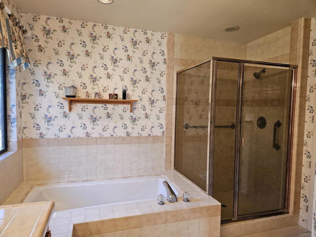 28124 Mountain Meadow Road Escondido, CA 92026 - Photo 17 of 31 a bathroom with a bathtub and shower