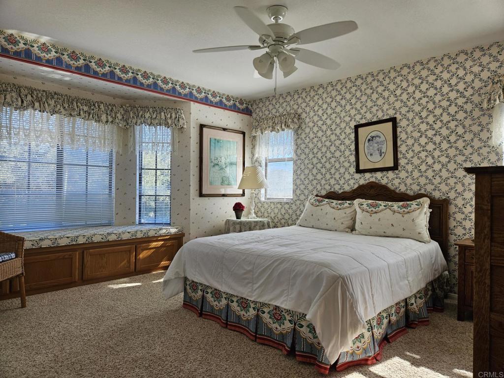 28124 Mountain Meadow Road Escondido, CA 92026 - Photo 18 of 31 a spacious bedroom with a bed and window