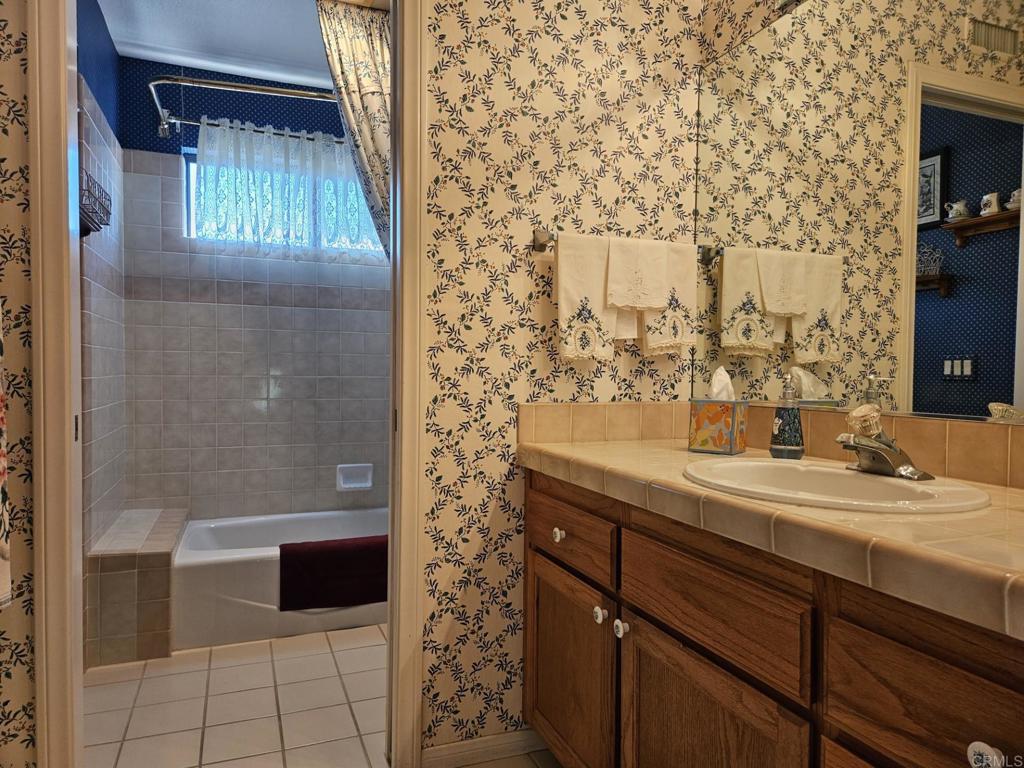 28124 Mountain Meadow Road Escondido, CA 92026 - Photo 19 of 31 a bathroom with a sink and a mirror