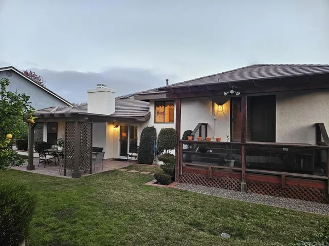 a view of a porch with furniture and a yard