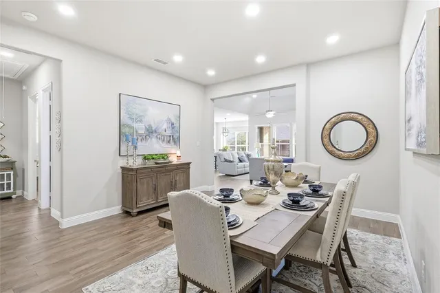 a dining room with furniture a mirror and a painting