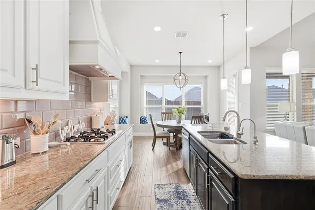 a dining room with furniture a chandelier and wooden floor