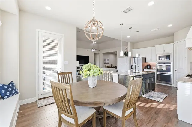 a spacious bedroom with a large bed and a chandelier