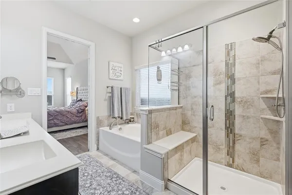a bathroom with a bathtub and a shower