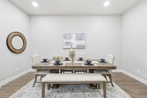 a dining room with furniture a mirror and a painting