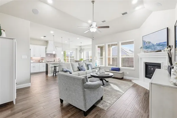 a living room with furniture a flat screen tv and a fireplace