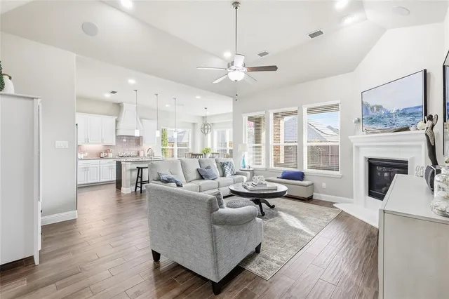 a living room with furniture a flat screen tv and a fireplace