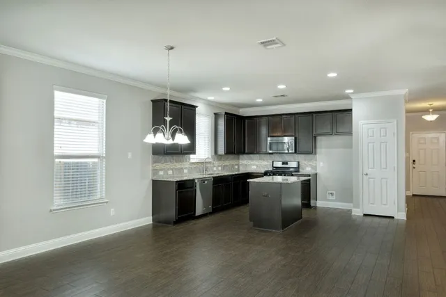 a kitchen with stove and cabinets