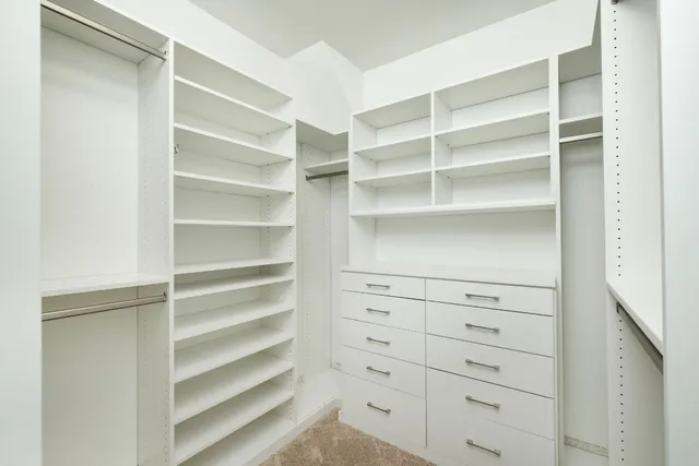 a view of walk in closet with empty racks