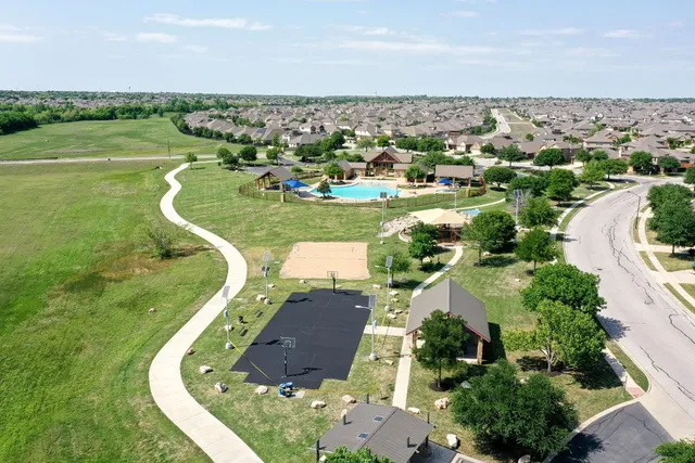 an aerial view of a house with a garden and lake view