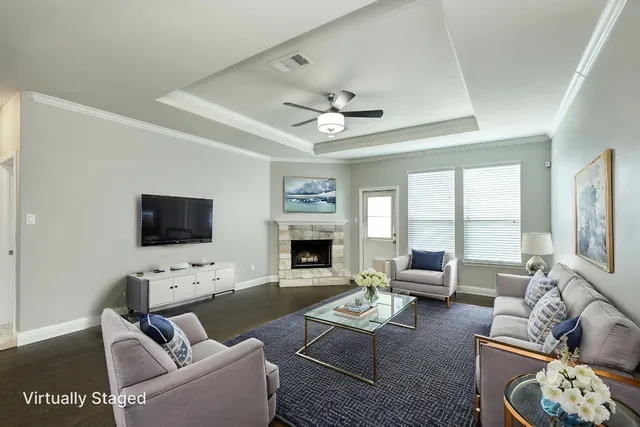 a living room with furniture a fireplace and a flat screen tv