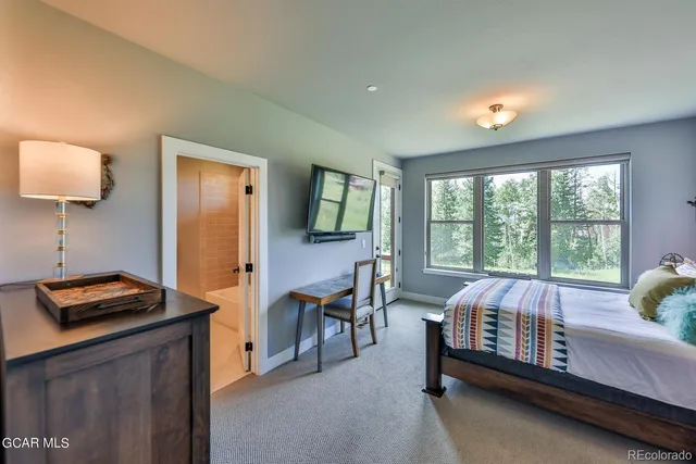 a bed room with a bed and a window