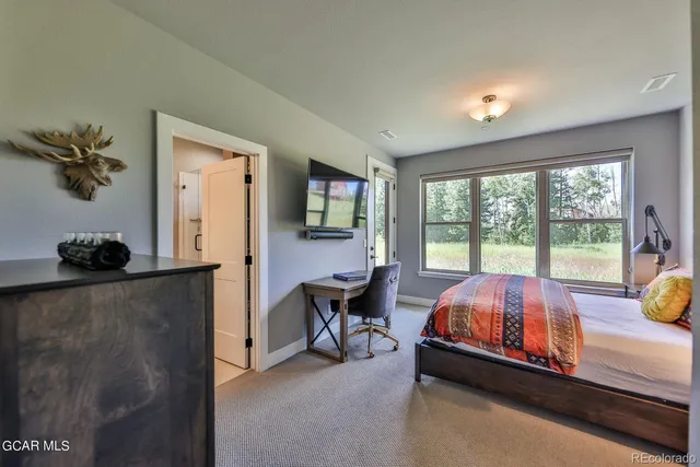 a bed room with a bed and a window