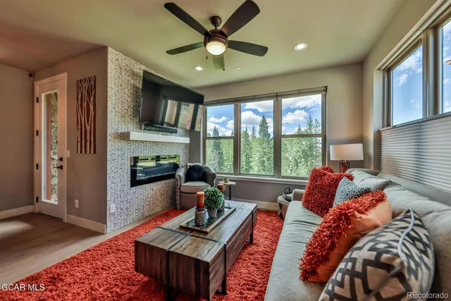 a living room with furniture and a open kitchen view