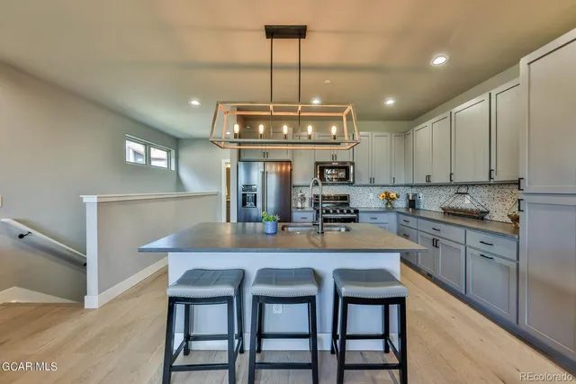 a kitchen with counter space dining table and chairs