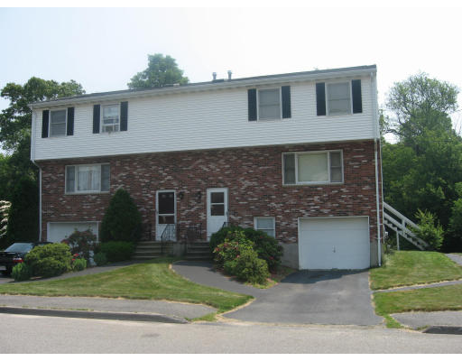 39 Christopher Road, Unit 39 Randolph, MA 02368 - Photo 1 of 1 a front view of a house with a yard and garage