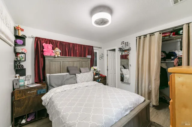 a bed sitting in a bedroom next to a window