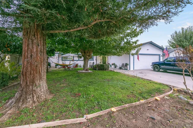 a view of a house with a backyard