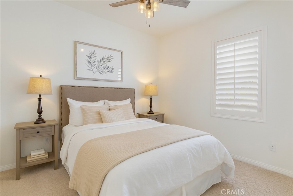 24536 Acadia Drive Corona, CA 92883 - Photo 11 of 40 a bedroom with a bed and a chandelier