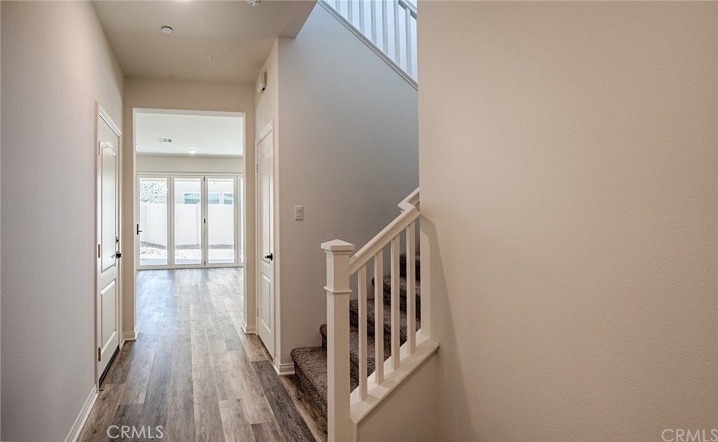 24536 Acadia Drive Corona, CA 92883 - Photo 2 of 40 a view of a hallway with wooden floor and staircase