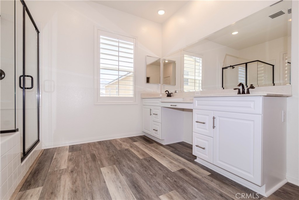 24536 Acadia Drive Corona, CA 92883 - Photo 21 of 40 a kitchen with a sink window and cabinets