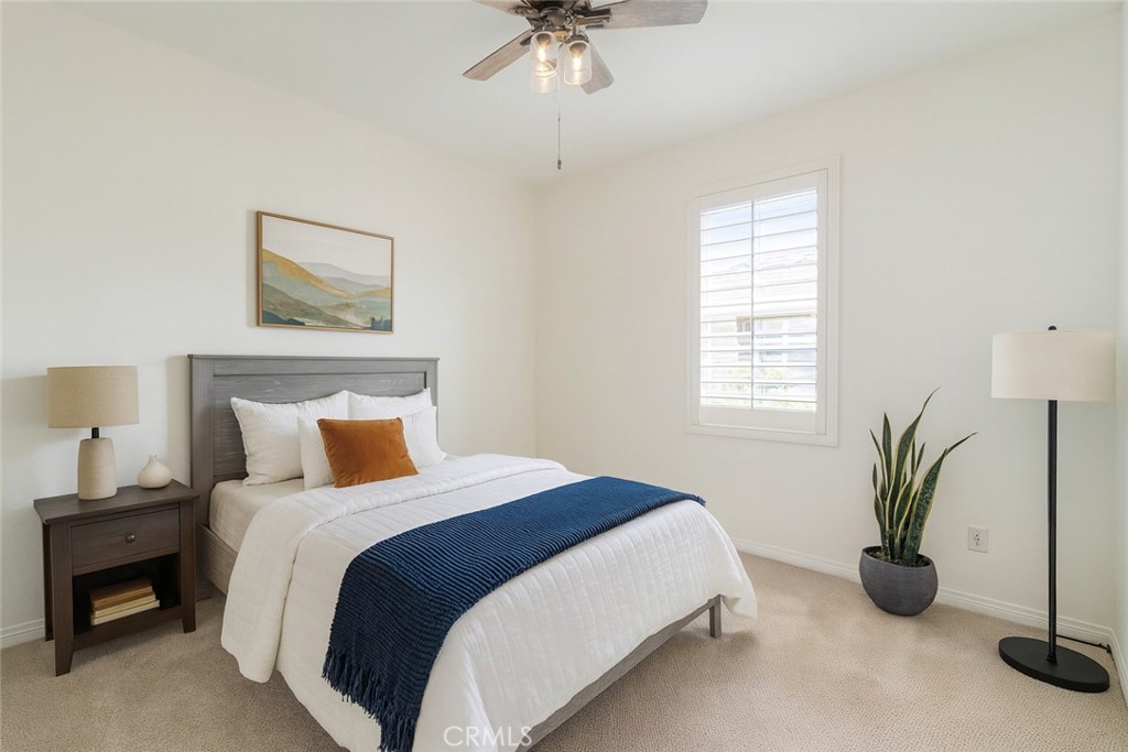 24536 Acadia Drive Corona, CA 92883 - Photo 24 of 40 a bedroom with a bed and a chandelier