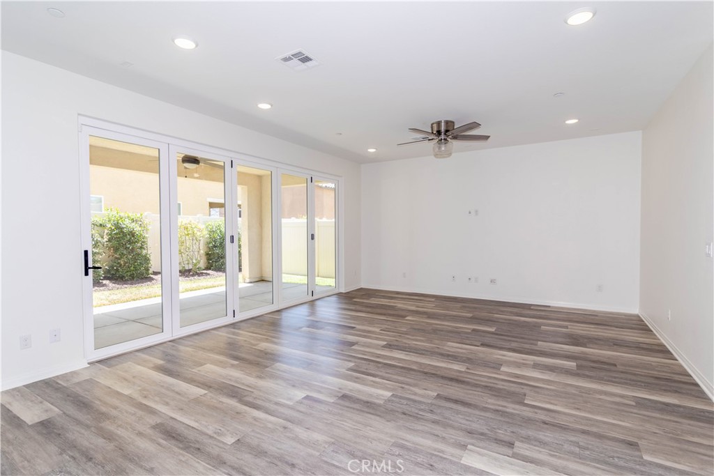 24536 Acadia Drive Corona, CA 92883 - Photo 4 of 40 a view of an empty room with a window and wooden floor