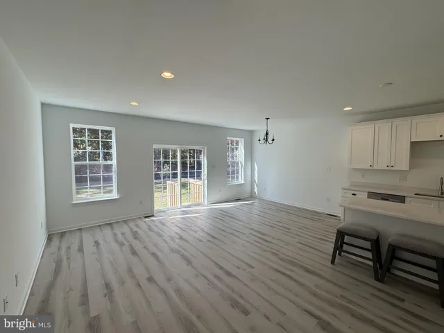 a view of work space with wooden floor and a window