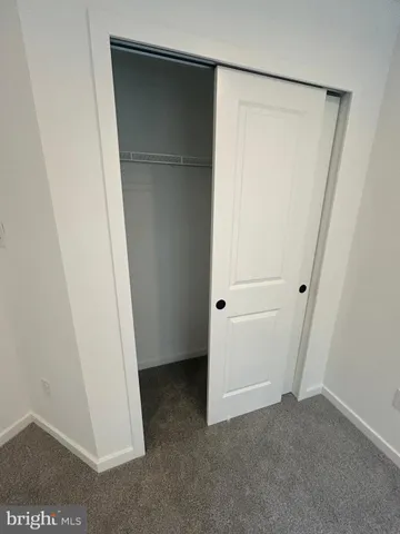 an empty room with windows and entrance