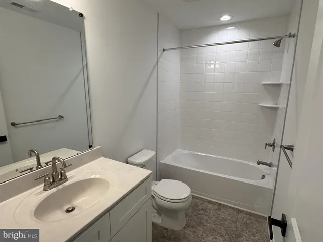 a bathroom with double vanity sink and a mirror