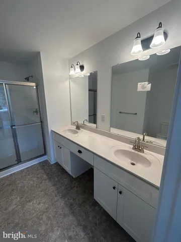 a bathroom with a double vanity sink mirror and double