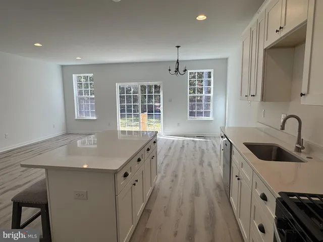 a kitchen with sink a faucet and appliances