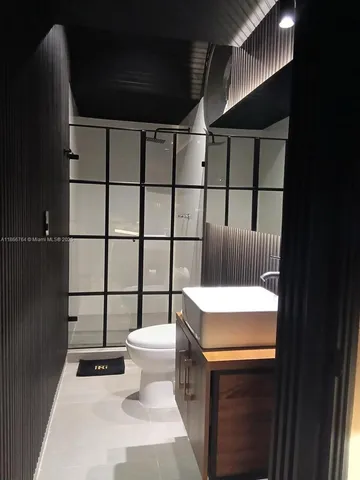 a kitchen with stainless steel appliances a stove and wooden floor