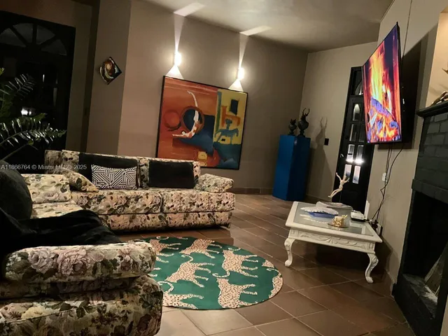 a room with red wall paintings and a lamp on desk