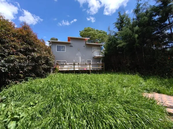 a view of backyard with swimming pool and outdoor seating