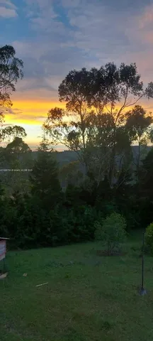 a living room with a open kitchen view and a fireplace