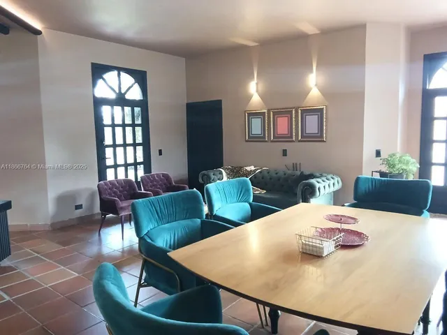 a dining room with furniture and window