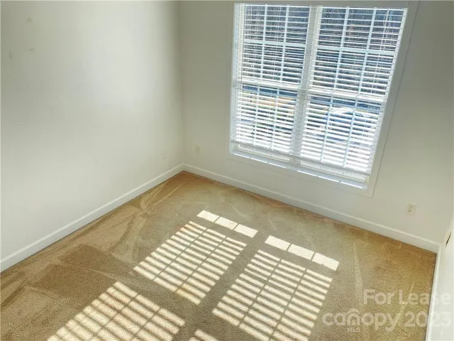 a view of a room with a white walls