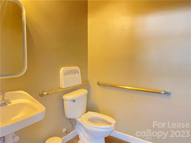 a toilet sitting in a bathroom next to a sink