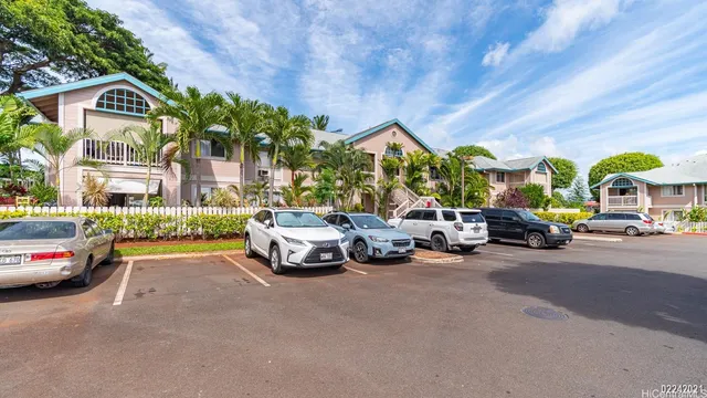 a view of a cars park in front of a building