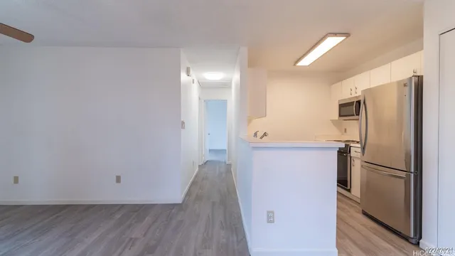 a kitchen with a refrigerator and a sink