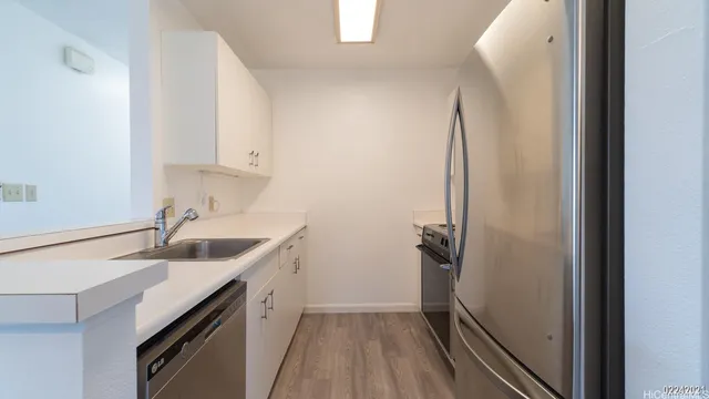a kitchen with sink and refrigerator