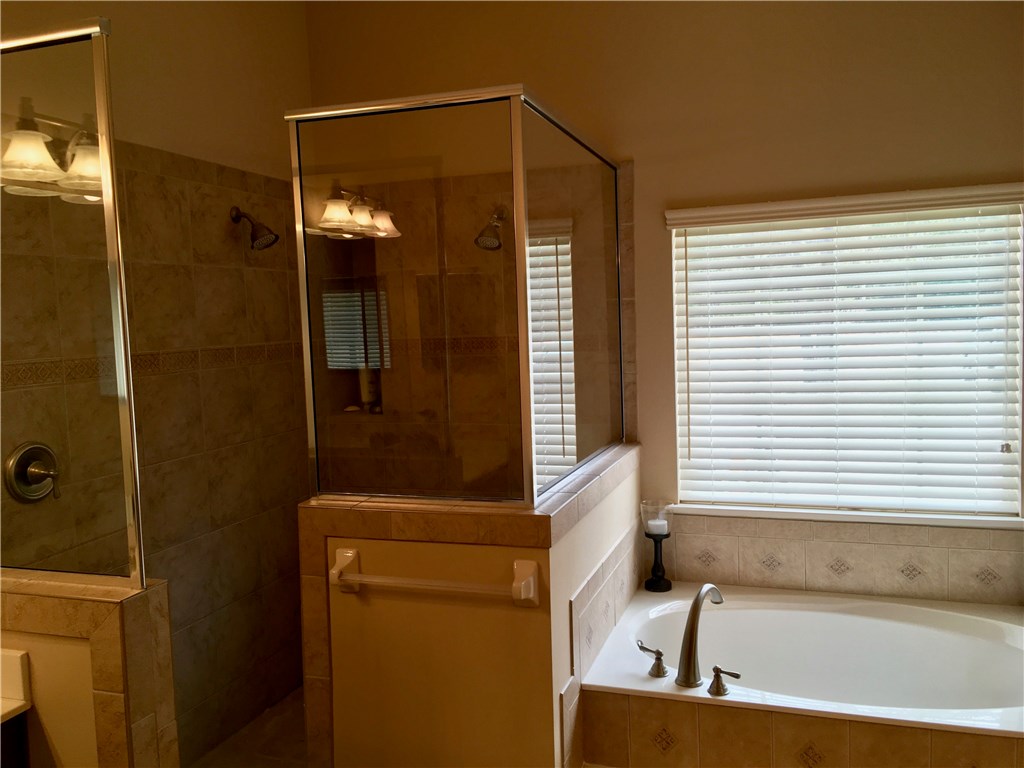 96525 Chester Road Yulee, FL 32097 - Photo 16 of 35 a bathroom with a tub and shower