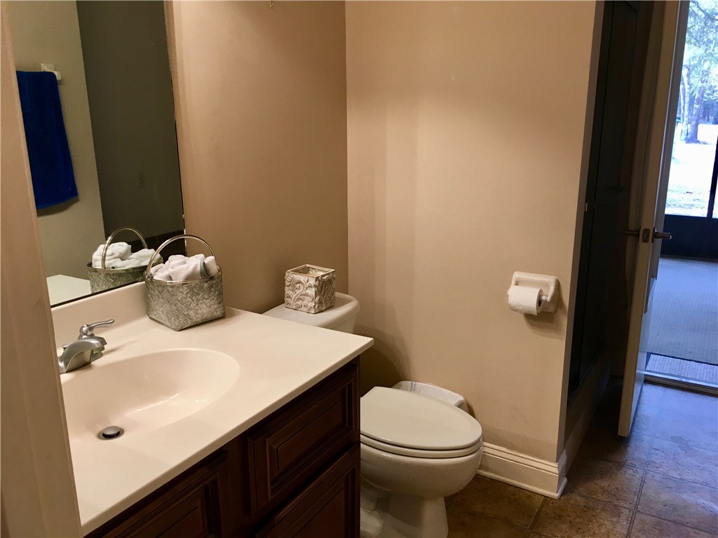 96525 Chester Road Yulee, FL 32097 - Photo 17 of 35 a bathroom with a sink a toilet and shower curtain