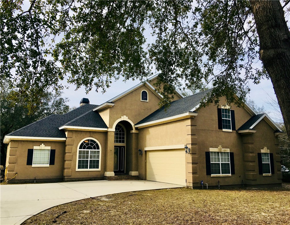 96525 Chester Road Yulee, FL 32097 - Photo 23 of 35 a front view of a house with a yard