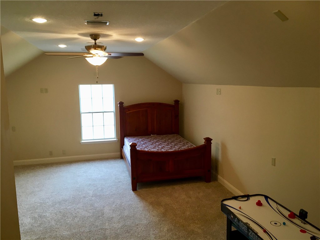96525 Chester Road Yulee, FL 32097 - Photo 25 of 35 a living room with furniture and a chandelier