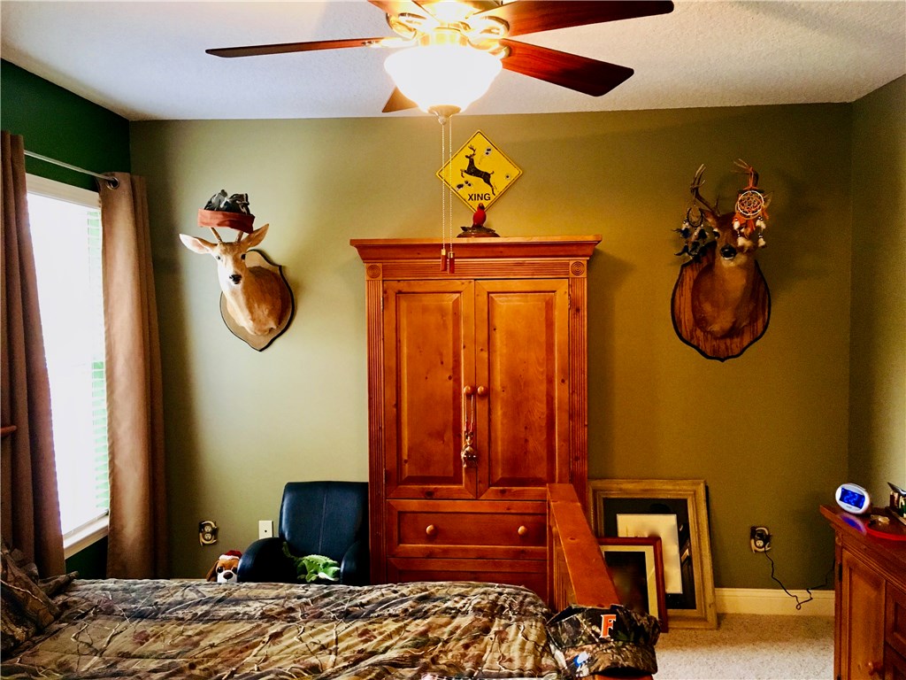 96525 Chester Road Yulee, FL 32097 - Photo 28 of 35 a bedroom with a bed and a chandelier