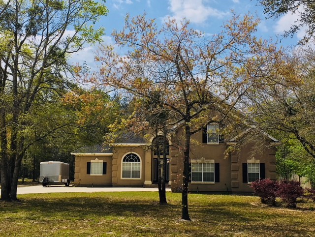 96525 Chester Road Yulee, FL 32097 - Photo 32 of 35 a front view of a house with a yard