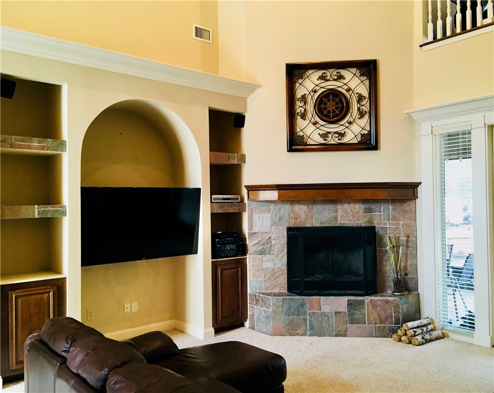 96525 Chester Road Yulee, FL 32097 - Photo 4 of 35 a living room with a flat screen tv and a fireplace